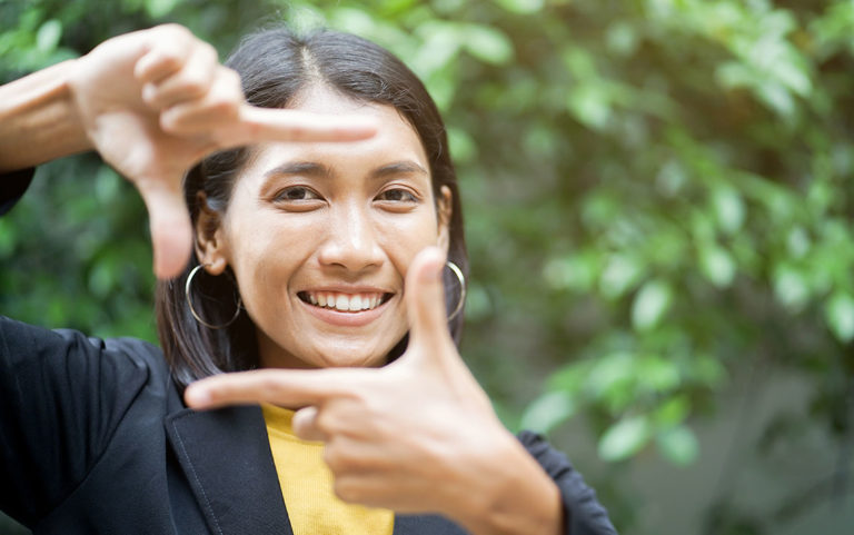 Woman framing her face with her hands